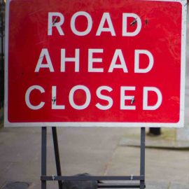 Image of a "Road Ahead Closed" sign